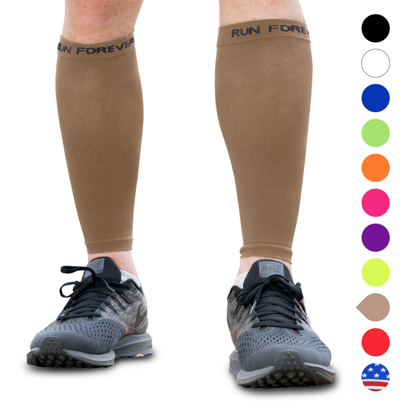 male runner in compression calf sleeve running forest trail Stock Photo by  realsportsphotos